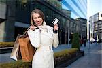 Smiling girl with shopping bags and credit card