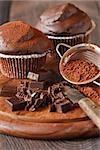 Sweet chocolate muffins and chocolate bars close-up.