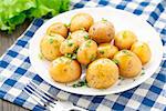 Potato with dill and scalliom on a plate