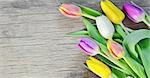 natural tulips on rustic wooden board, easter decoration