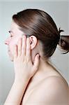 Young woman touching her painful ear