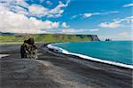 Beautiful rock formation on a black volcanic beach at Cape Dyrholaey, the most southern point of Iceland.