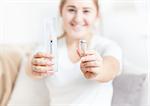 Photo of young woman holding syringe