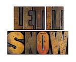 The words LET IT SNOW written in vintage letterpress type