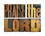 The words PRAISE THE LORD written in vintage letterpress type