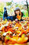 beautiful girl lying on a glade in autumn forest