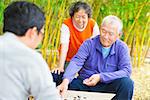 seniors play traditional chinese board game Go