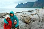 Family and summer night coast (polar day). The dragon's teeth rock,  Jagged Ersfjord, Senja, Norway .