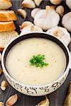 Garlic cream soup with parsley in a bowl.