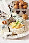 Delicious cheese platter with crackers, honey and nuts.