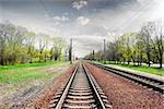 Gray cloudy sky over railroad in spring