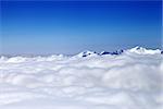 Mountains under clouds at nice day. Caucasus Mountains, Georgia, Gudauri. View from ski slope.