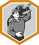 Illustration of a electrician worker with electric plug carrying on shoulder facing front set inside shield crest on isolated background done in retro style.