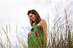 Pregnant woman standing in field