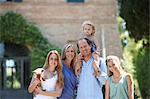 Parents standing with daughters and dog in garden