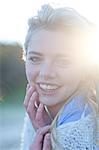 Portrait of young woman huddled up in blanket