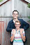 Portrait of father and teenage son in garden