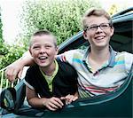 Portrait of two brothers leaning out of car window