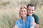 Portrait of mid adult couple in sandunes, Thurlestone, Devon, UK