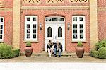 Father and son sitting on doorstep