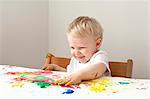 Little boy playing with finger paints