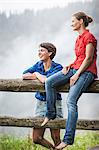 Two female friends looking at view, Tyrol Austria