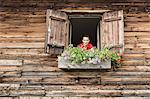 Portrait of mid adult woman at chalet window, Achenkirch,  Tyrol, Austria