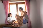 Young woman and daughter in holiday chalet, Tyrol, Austria