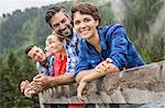 Group of friends leaning on wooden fence, Tirol, Austria