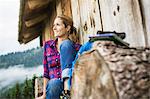 Woman enjoying the view from wooden shack, Tirol, Austria