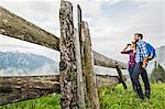 Couple enjoying view through binoculars, Tirol, Austria