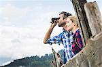 Close up of couple enjoying view through binoculars, Tirol, Austria