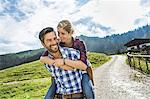 Woman riding piggyback on man, Tirol, Austria