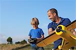 Father and son preparing model plane