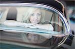 Woman looking out of rear car windscreen