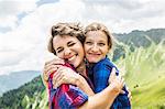Two female friends hugging, Tyrol, Austria