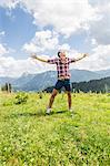 Portrait of young man with arms out, Tyrol, Austria