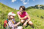 Mother and daughter discovering plants, Tyrol, Austria