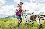 Father and daughter with goats, Tyrol, Austria