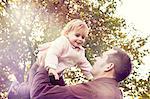 Father lifting toddler