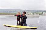 Father teaching son how to surf