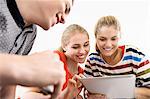 Three young adult friends with digital tablet