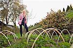 Mature woman standing in vegetable garden