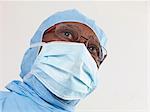Surgeon wearing surgical scrubs and protective mask