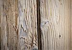 A reclaimed lumber workshop. Close up of two planks of wood, with knots and wood grain patterns.