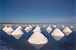 Piles of salt dry in the arid atmosphere of Bolivia's Salar de Uyuni.