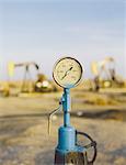 Air pressure gauge, oil rigs in background, Sunset-Midway oil fields, the largest in California.