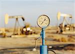 Air pressure gauge, oil rigs in background, Sunset-Midway oil fields, the largest in California.