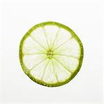 Organic lime slice on white background