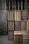 A stack of wooden crates, in the corner of a room.